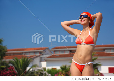 beautiful young woman in red swimsuit and sunglasses stands on b 4799876