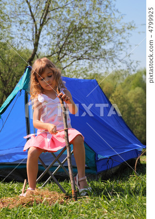 beautiful little girl in pink dress sitting near blue tent on na beautiful little girl in pink dress sitting near blue tent on na 4799925
