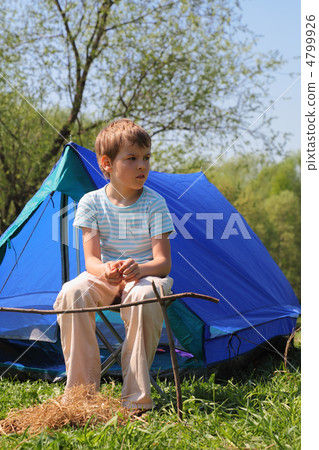 little boy in striped shirt sitting near blue tent on nature little boy in striped shirt sitting near blue tent on nature 4799926