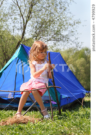 beautiful little girl in pink dress sitting near blue tent on na beautiful little girl in pink dress sitting near blue tent on na 4799929