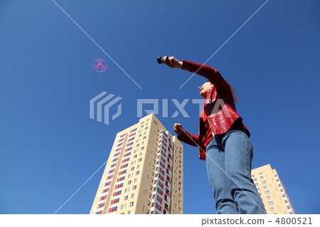 beautiful young woman in red jacket and blue jeans playing with beautiful young woman in red jacket and blue jeans playing with 4800521