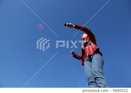 beautiful young woman in red jacket and blue jeans playing with beautiful young woman in red jacket and blue jeans playing with 4800522