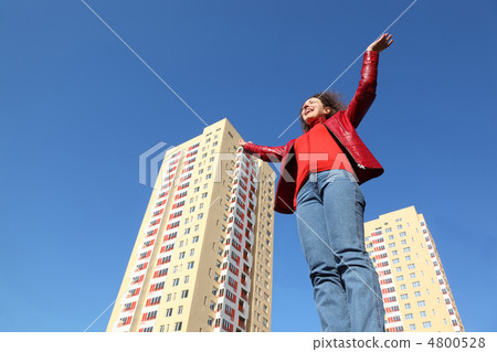 beautiful young woman in red jacket and blue jeans raises his ha beautiful young woman in red jacket and blue jeans raises his ha 4800528