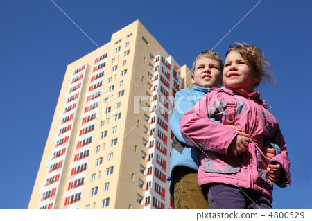 brother hugs little sister. girl in pink jacket, boy in blue jac brother hugs little sister. girl in pink jacket, boy in blue jac 4800529