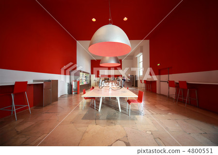 people in small cozy cafe. white tables, red chairs and walls 4800551