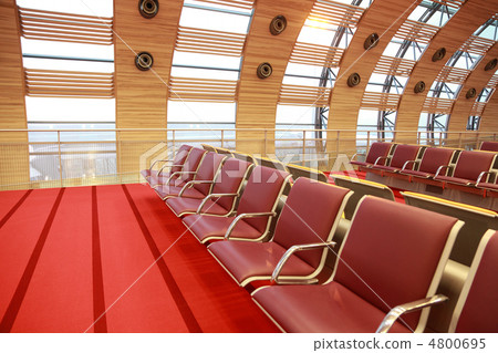 Empty waiting room at airport, red floor and armchair, big windo 4800695
