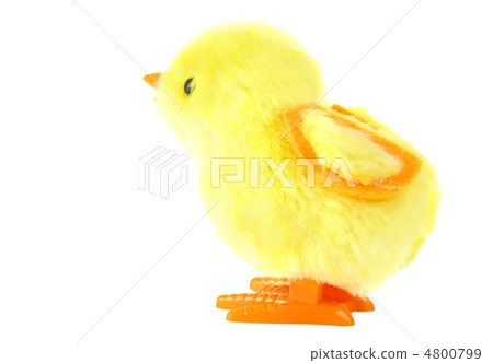 side view of clockwork toy fluffy yellow chick with orange feet 4800799