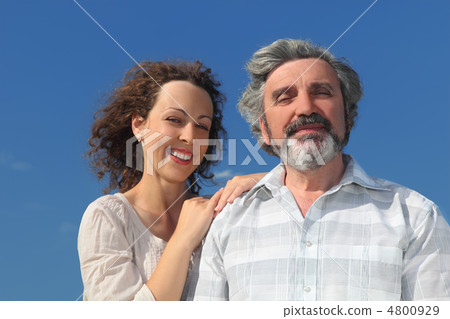 portrait of young woman embracing her father and smiling, blue s portrait of young woman embracing her father and smiling, blue s 4800929