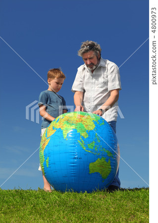 boy and his grandfather standing on lawn and looking on big infl 4800973