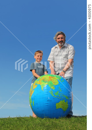 boy and his grandfather standing on lawn near big inflatable glo boy and his grandfather standing on lawn near big inflatable glo 4800975