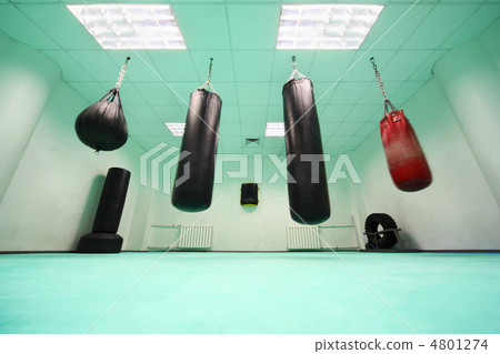 empty light green room, where black and red punching bag hang empty light green room, where black and red punching bag hang 4801274