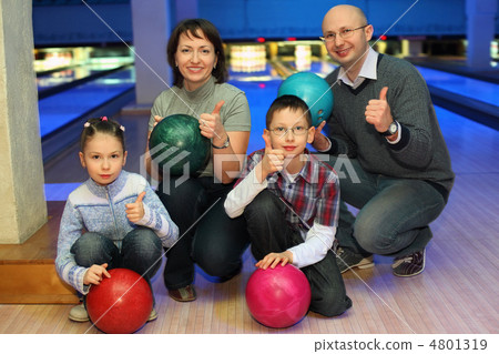 Family of squatting in bowling club and shows  hands of ok, focu 4801319