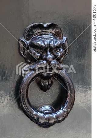 big beautiful metal doorknob, holding human head in his mouth st 4801575