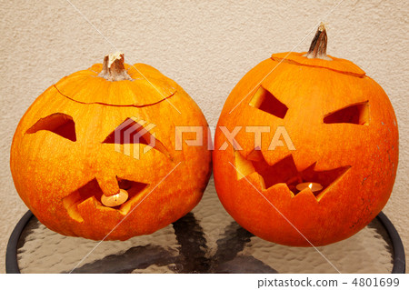 Two pumpkins of Halloween lie on glass little table Two pumpkins of Halloween lie on glass little table 4801699
