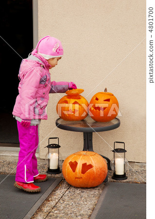 Little child considers Halloween pumpkin. Focus on the top pumpk 4801700