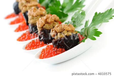 Prunes stuffed with liver pate with nuts in a red caviar Prunes stuffed with liver pate with nuts in a red caviar 4810575