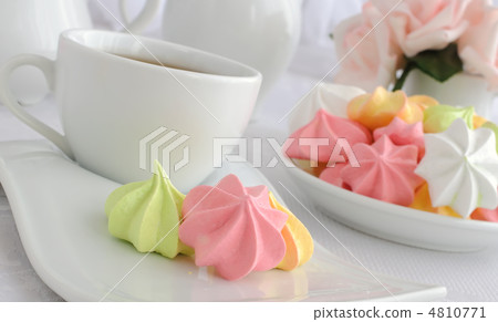 Meringue cookies on a plate with a cup of coffee Meringue cookies on a plate with a cup of coffee 4810771