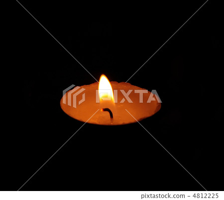 A single burning yellow candle A single burning yellow candle 4812225