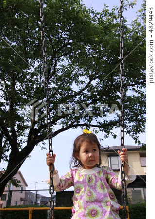 A girl riding a swing A girl riding a swing 4829443