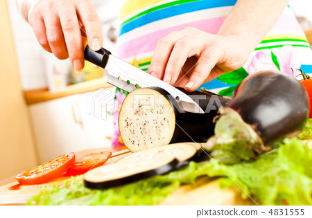 Woman's hands cutting aubergine eggplant 4831555
