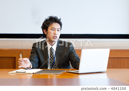 Male employee who works with pen on the right hand and laptop with left hand 4841108