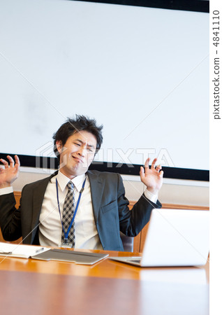 A salaryman who stretches as if she gets caught while watching a laptop computer A salaryman who stretches as if she gets caught while watching a laptop computer 4841110