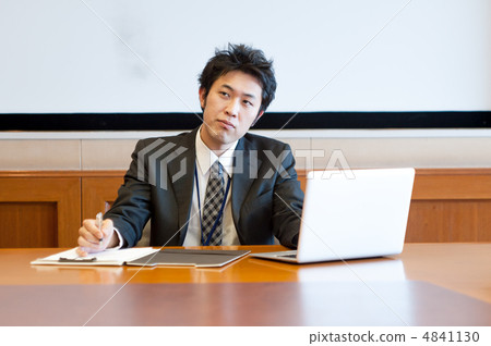 Male office worker thinking while working in front of laptop computer and materials 4841130