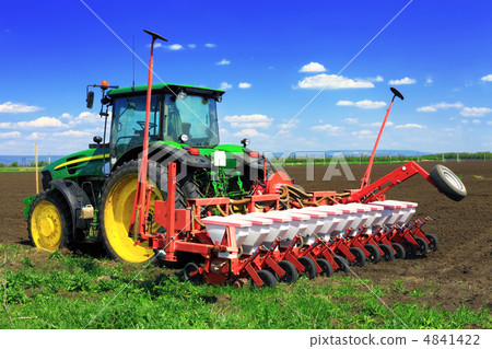 Tractor plowing the fields in early spring. 4841422