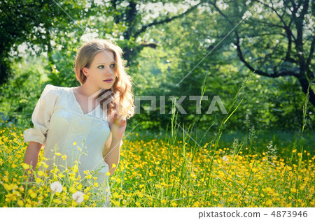 beautiful young girl in nature, in a field of flowers beautiful young girl in nature, in a field of flowers 4873946