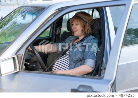 Pregnant woman in driving seat of the car Pregnant woman in driving seat of the car 4874225