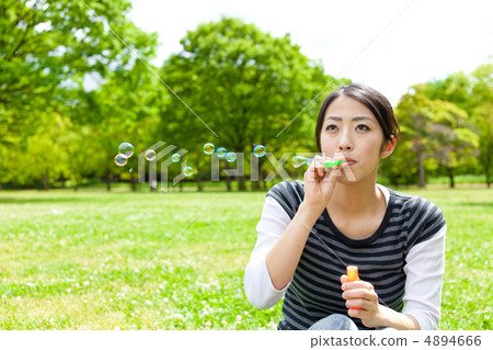 Woman blowing soap bubble Woman blowing soap bubble 4894666