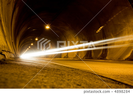 lone car moving fast in tunnel 4898284
