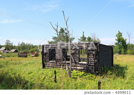burned rural house on green field 4899011