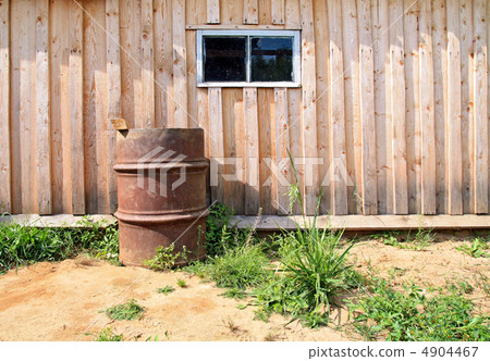 rusty barrel near wooden shed rusty barrel near wooden shed 4904467