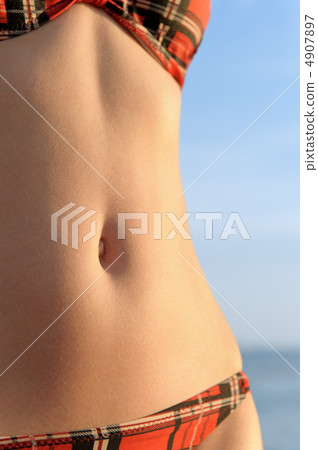 Beautiful female body against the blue sky. 4907897