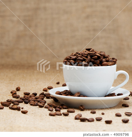 White cup with coffee grains White cup with coffee grains 4909796