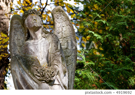 Monument to an angel on a cemetery Monument to an angel on a cemetery 4919692