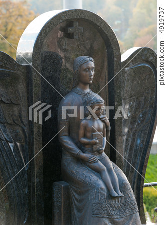 Monument of the woman with the child on a cemetery 4919737