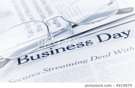 Eyeglasses lie on the newspaper with title Business day. Blue to Eyeglasses lie on the newspaper with title Business day. Blue to 4919974