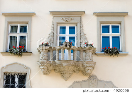 Facade of a building with a balcony and flowers 4920096