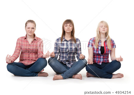 Three girls sitting in lotus posture 4934254