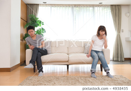 A couple sitting on the sofa in the living room 4938435