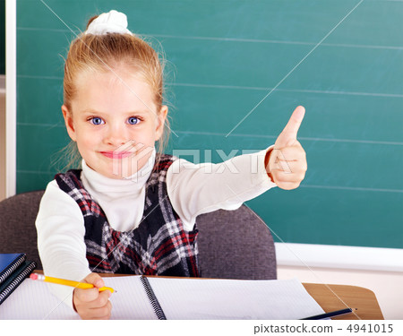Schoolchild in classroom near blackboard. Schoolchild in classroom near blackboard. 4941015