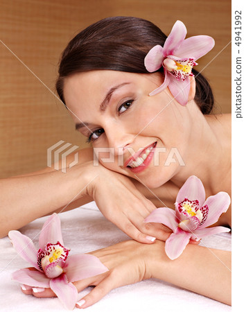 Young woman on massage table in beauty spa. 4941992