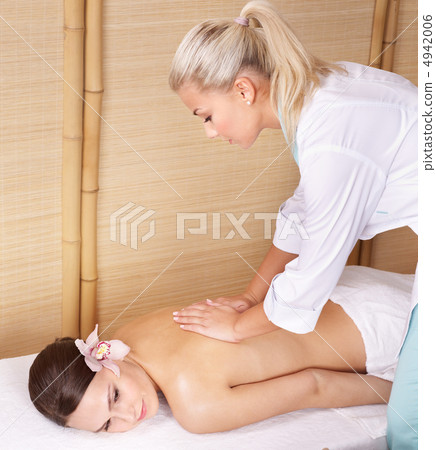 Young woman on massage table in beauty spa. 4942006