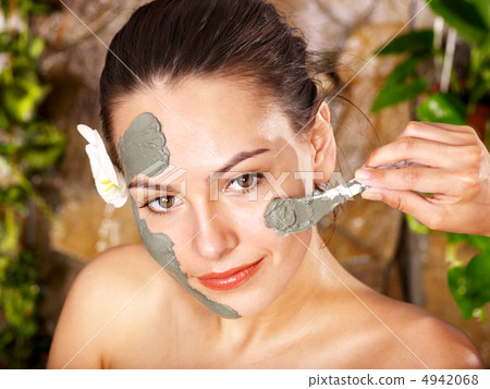 Young woman  having clay body mask. 4942068