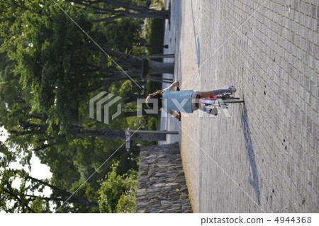 The back of a girl riding a bicycle 4944368