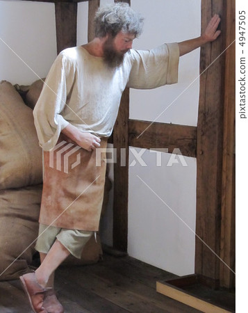A man waiting while leaning against the wall that the material of the leather made by John Shakespeare arrives A man waiting while leaning against the wall that the material of the leather made by John Shakespeare arrives 4947505