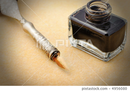 Feather quill and inkwell on an old paper Feather quill and inkwell on an old paper 4956080