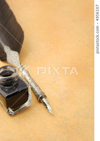 Feather quill and inkwell on an old paper Feather quill and inkwell on an old paper 4956107